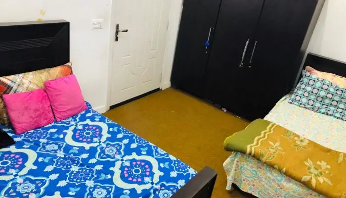 Spacious three‑seater girls hostel room near UMT offering modern furniture and a welcoming environment.